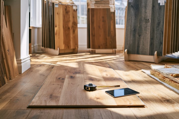 Flooring store with oak planks laid out as samples on the floor