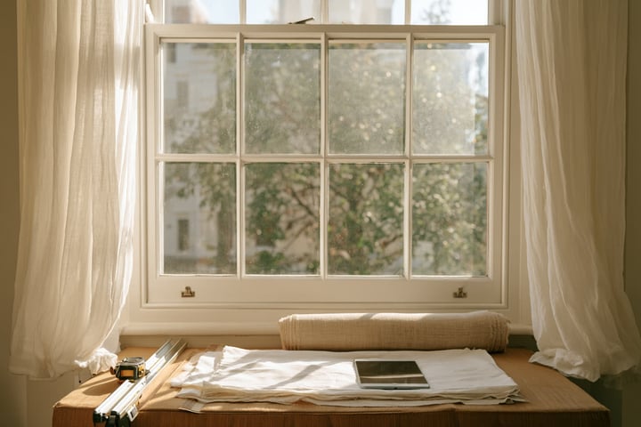 Bright living room with a large window and window coverings